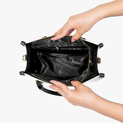 Inside view of black Coon Women's Tote Bag held open by hands, showing spacious interior with zipper pocket